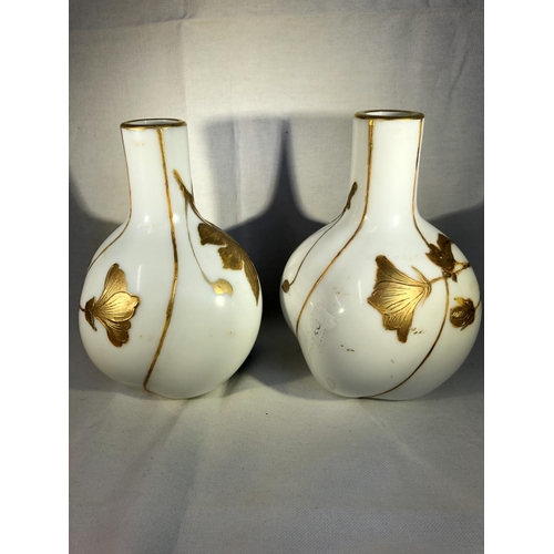 94 - Harrach,  - a pair of lobed melon form bottle vases, the white ground enamelled with sage green stri... 