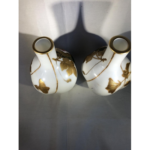 94 - Harrach,  - a pair of lobed melon form bottle vases, the white ground enamelled with sage green stri... 