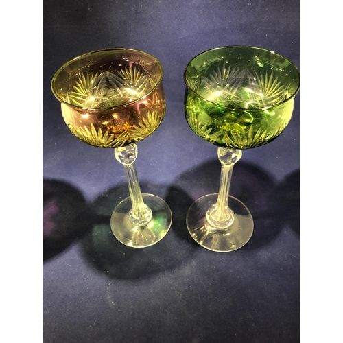 63 - Continental Glass - Two two colour overlay hock glasses, the bowls of green; and amethyst over yello... 