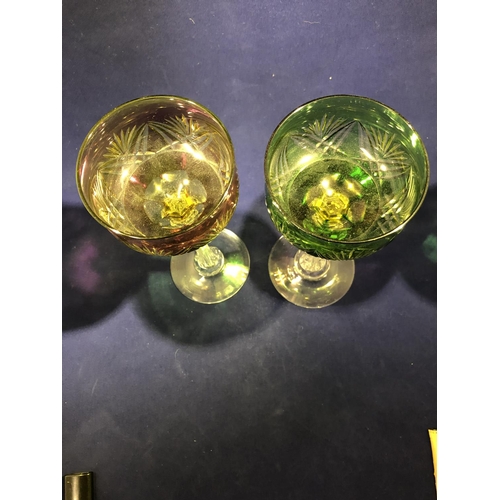 63 - Continental Glass - Two two colour overlay hock glasses, the bowls of green; and amethyst over yello... 