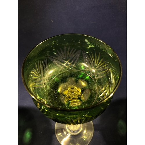 63 - Continental Glass - Two two colour overlay hock glasses, the bowls of green; and amethyst over yello... 