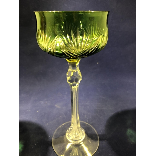 63 - Continental Glass - Two two colour overlay hock glasses, the bowls of green; and amethyst over yello... 