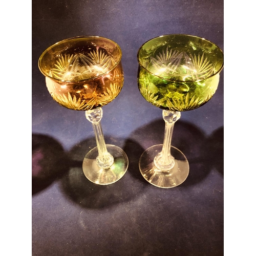 63 - Continental Glass - Two two colour overlay hock glasses, the bowls of green; and amethyst over yello... 