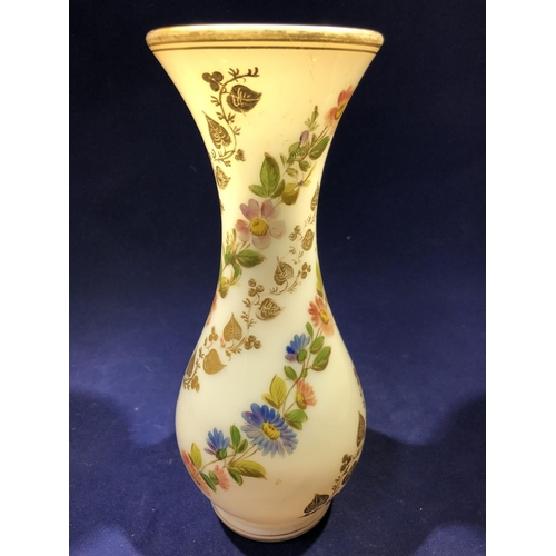 68 - Baccarat - a white opaline glass vase, gilded with vines and enamelled with floral swags, 20cm high