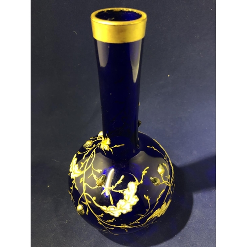 117 - Moser - a cobalt blue bottle vase, enamelled and gilded with oak leaves and branches with applied si... 