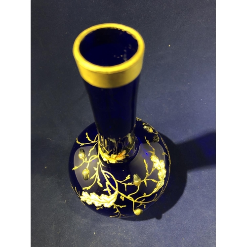 117 - Moser - a cobalt blue bottle vase, enamelled and gilded with oak leaves and branches with applied si... 