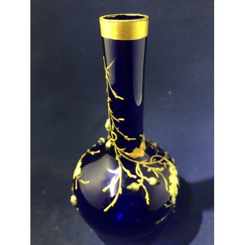 117 - Moser - a cobalt blue bottle vase, enamelled and gilded with oak leaves and branches with applied si... 