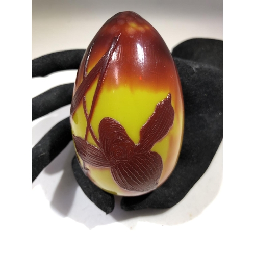 81 - Daum - a rare cameo glass egg form hand cooler, the cherry red cameo cut through to lemon yellow wit... 