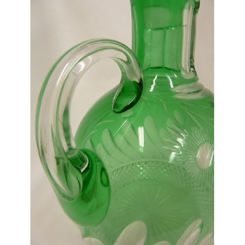 245 - Stevens and Williams - a glass Whisky decanter and stopper, the green casing cut through to clear wi... 