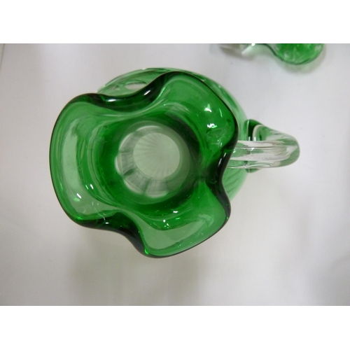 245 - Stevens and Williams - a glass Whisky decanter and stopper, the green casing cut through to clear wi... 