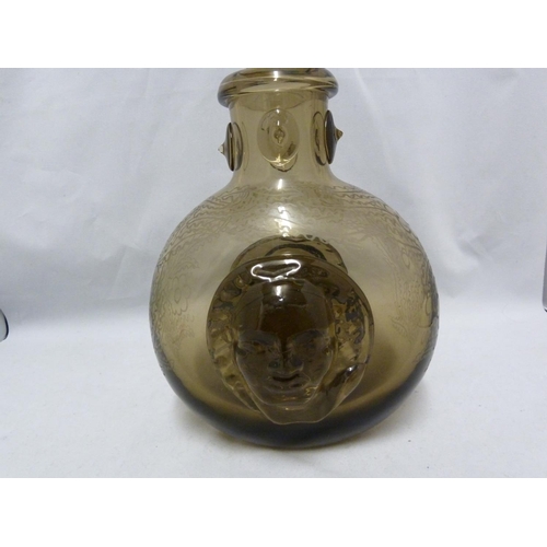 56 - Seguso - a  dark amber glass flask, the flattened globular body applied with a female head to each s... 