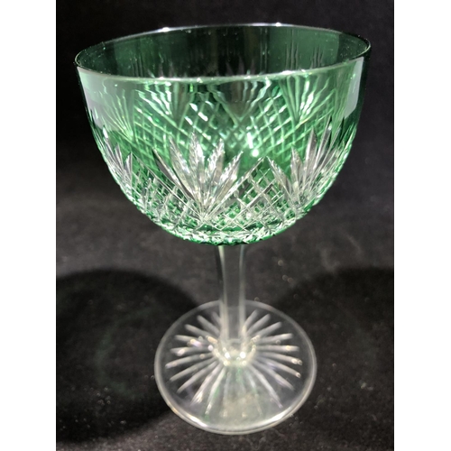 246 - Stevens and Williams - a pair of green overlay wine glasses, the bowls cut through to colourless gla... 