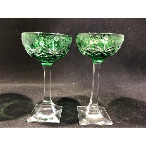 247 - Stevens and Williams - a pair of green overlay glass cocktail coupes, the green bowls cut through to... 