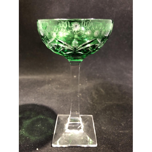 247 - Stevens and Williams - a pair of green overlay glass cocktail coupes, the green bowls cut through to... 