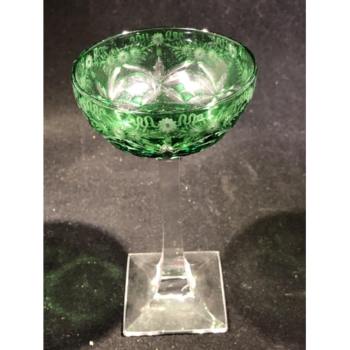 247 - Stevens and Williams - a pair of green overlay glass cocktail coupes, the green bowls cut through to... 