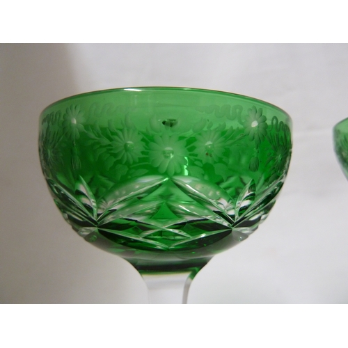 247 - Stevens and Williams - a pair of green overlay glass cocktail coupes, the green bowls cut through to... 