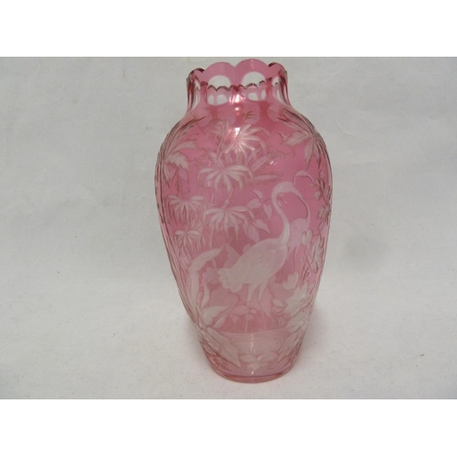 119 - French Glass, possibly Baccarat, an intaglio cut vase of pale cranberry cut to colourless with crane... 