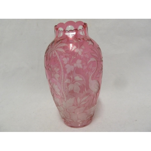 119 - French Glass, possibly Baccarat, an intaglio cut vase of pale cranberry cut to colourless with crane... 