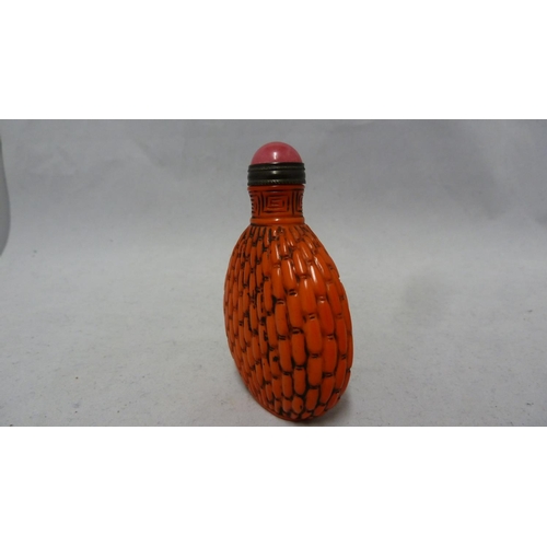 96 - Chinese Glass - a red glass snuff bottle formed to simulate cinnabar lacquer, bronze metal mount to ... 