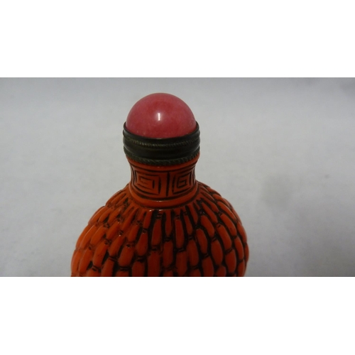 96 - Chinese Glass - a red glass snuff bottle formed to simulate cinnabar lacquer, bronze metal mount to ... 