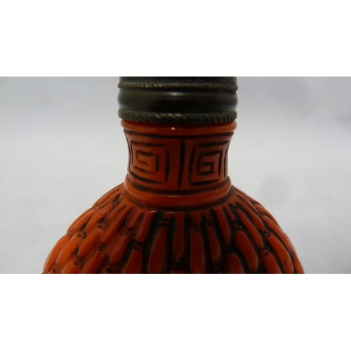 96 - Chinese Glass - a red glass snuff bottle formed to simulate cinnabar lacquer, bronze metal mount to ... 