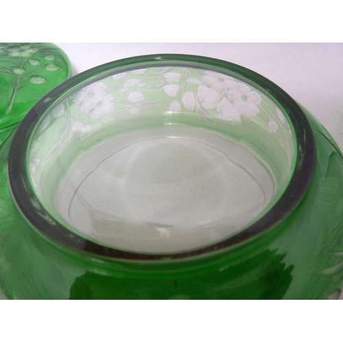 255 - Stevens and Williams - an intaglio cut glass powder bowl cover and underdish, of green cut through t... 