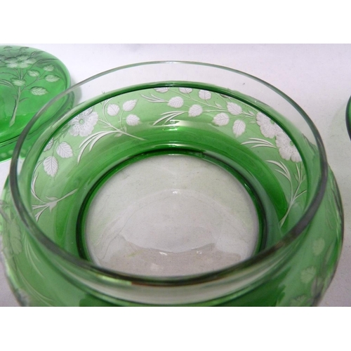 255 - Stevens and Williams - an intaglio cut glass powder bowl cover and underdish, of green cut through t... 