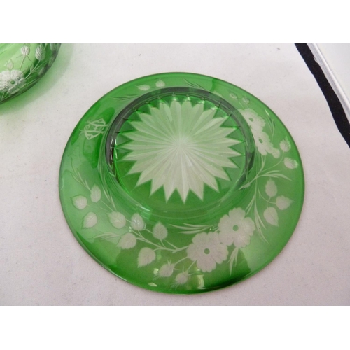 255 - Stevens and Williams - an intaglio cut glass powder bowl cover and underdish, of green cut through t... 