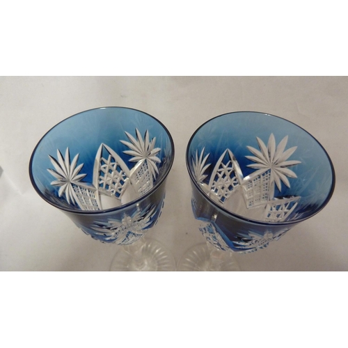 114 - Saint Louis - a pair of blue overlay wine glasses, the bowls cut through to colourless with diamond ... 