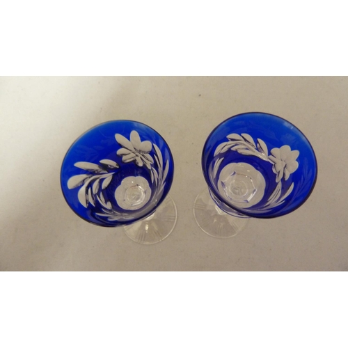 205 - Thomas Webb - two small overlay wine glasses, the cobalt blue cut through to colourless with a flora... 