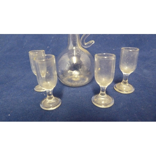 82 - Dolls House interest - a miniature lampwork glass set of wine jug and four wine glasses, colourless ... 