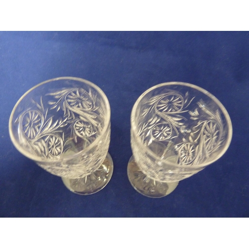 220 - Tudor Glass - Two Catherine of Aragon pattern wine glasses, cut with foliate scrolls, on short stems... 