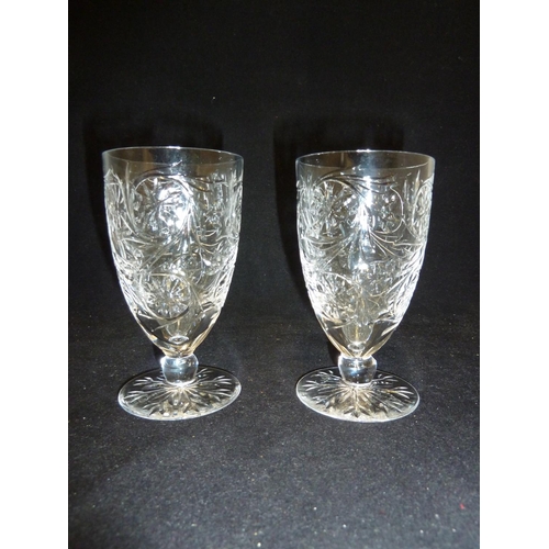 220 - Tudor Glass - Two Catherine of Aragon pattern wine glasses, cut with foliate scrolls, on short stems... 