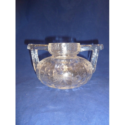 259 - Stevens & Williams - a Rock Crystal two handled vase, the flattened globular body cut with floral sp... 