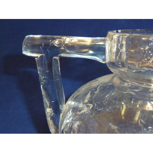 259 - Stevens & Williams - a Rock Crystal two handled vase, the flattened globular body cut with floral sp... 