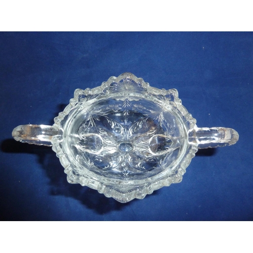 125 - French Glass - a moulded colorless glass sugar box and cover, in the Rock Crystal style, the two han... 