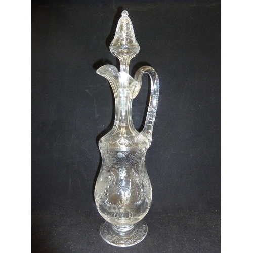 258 - Stevens & Williams - a Rock Crystal glass claret jug and stopper, the pear form body with high loope... 