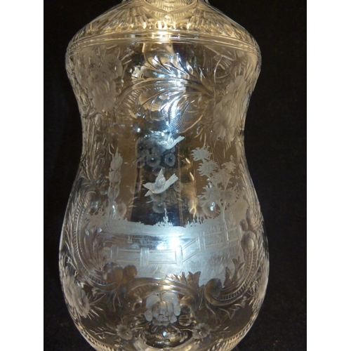 258 - Stevens & Williams - a Rock Crystal glass claret jug and stopper, the pear form body with high loope... 