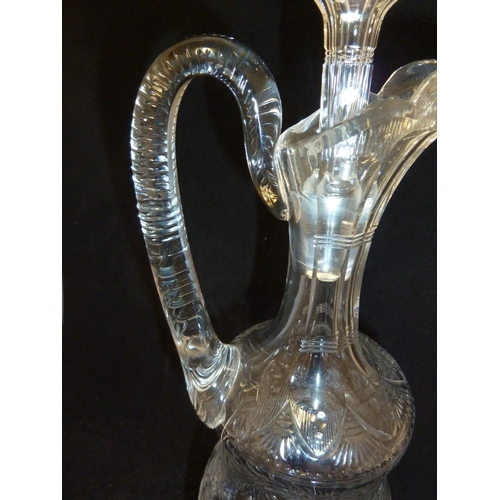 258 - Stevens & Williams - a Rock Crystal glass claret jug and stopper, the pear form body with high loope... 