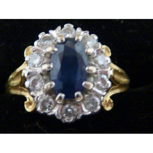 94 - A sapphire and diamond set 18ct yellow gold ring, the oval sapphire encircled by 11 diamonds, ring s... 