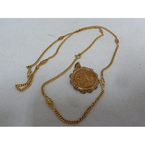 10 - A gold Sovereign coin, dated 1922, mounted as a pendant and with a yellow gold fancy link chain mark... 