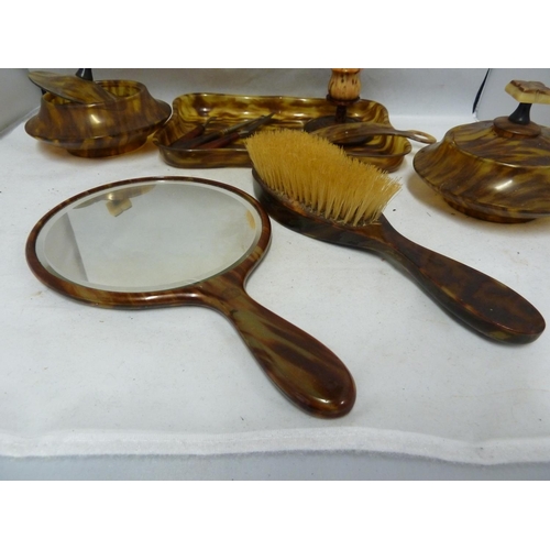 105 - An early plastic Art Deco Dressing table set, includes tray, powder bowl, hair pot and cover, candle... 