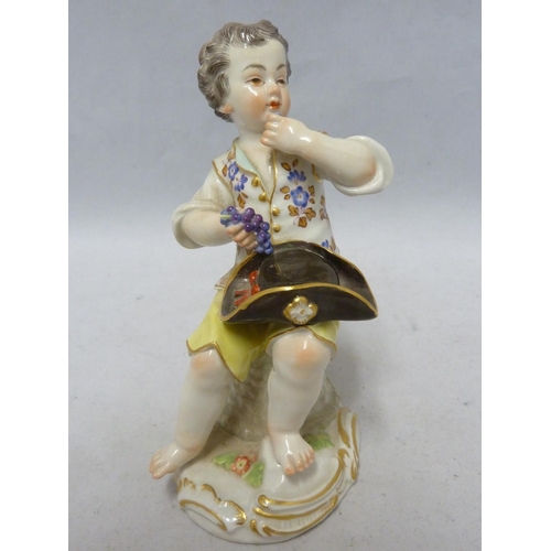 111 - A Meissen porcelain figure, of a seated boy eating grapes, on foliate scroll base, blue crossed swor... 