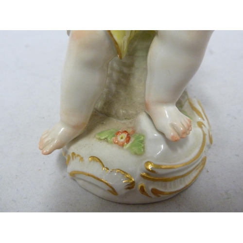 111 - A Meissen porcelain figure, of a seated boy eating grapes, on foliate scroll base, blue crossed swor... 