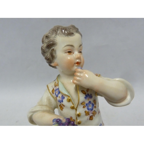 111 - A Meissen porcelain figure, of a seated boy eating grapes, on foliate scroll base, blue crossed swor... 