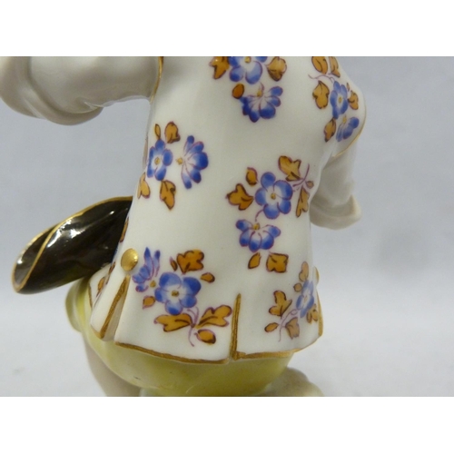 111 - A Meissen porcelain figure, of a seated boy eating grapes, on foliate scroll base, blue crossed swor... 