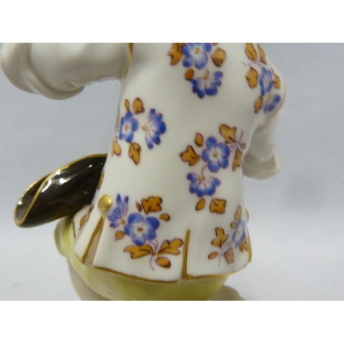 111 - A Meissen porcelain figure, of a seated boy eating grapes, on foliate scroll base, blue crossed swor... 