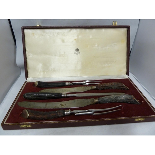 133 - Asprey - a five piece carving set, in fitted case, antler handles.