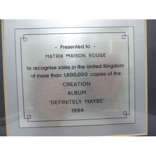 136 - Oasis, Definitely Maybe - an In-house award mounted CD Disk, presented to Matrix Maison Rouge to rec... 