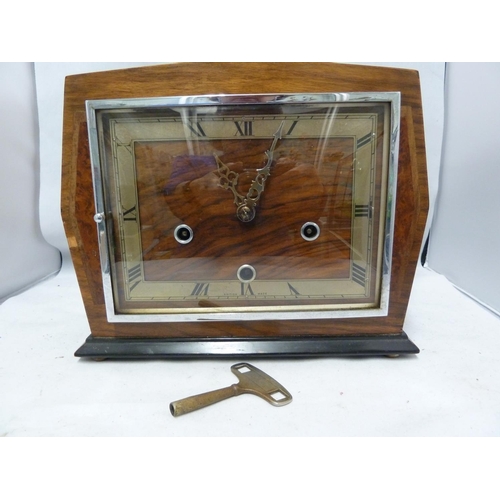 148 - Enfield Clock Co (London) Limited - An Art Deco Chiming mantel clock, with marquetry case, dial mark... 